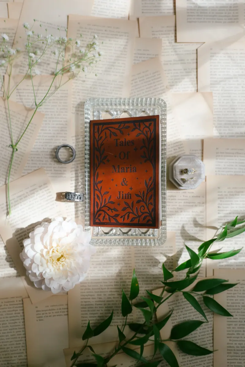 Book invitation opened to engraved interior pages