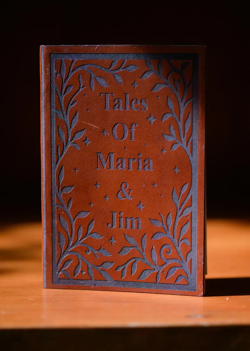 Leather-bound book invitation on a vintage glass tray